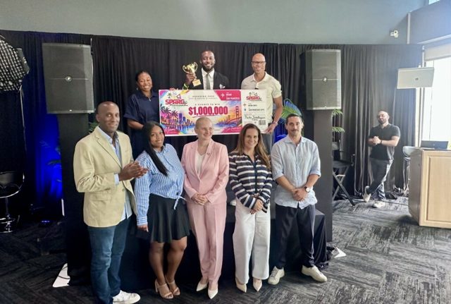 SPARC Ignite 2026 participants and organizers on stage with an oversized prize check and trophy